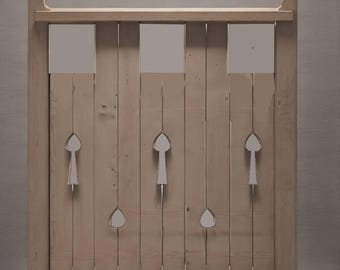 Könnte beinhalten: Ein hellbraunes Holztor mit vertikalen Brettern und dekorativen Ausschnitten. Das Tor hat quadratische und tropfenförmige Öffnungen, mit einem horizontalen Oberteil und einem dekorativen Element oben.