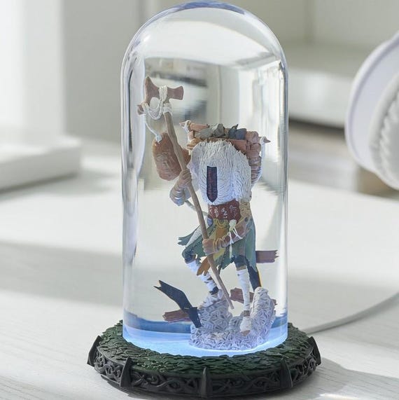 A resin lamp sculpted as a masked forest maiden — genuinely striking fantasy art that doubles as mood lighting for a gaming or creative desk.