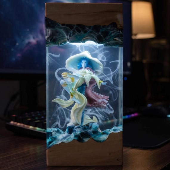 Hand-poured resin night light sculpted into a mystical moon witch scene — the kind of glowing desk piece that stops guests mid-sentence.