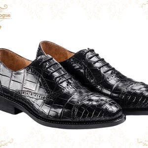 Handmade men’s black crocodile-style textured leather lace-up dress shoes with a polished finish. Crafted with genuine leather upper, cushioned insole, leather lining, and durable outsole for all-day comfort and support. Designed for weddings, parties, office wear, and formal business occasions. A premium handmade shoe that blends luxury, craftsmanship, and timeless sophistication for modern gentlemen. mens formal shoes
wedding shoes men
party wear shoes
business shoes men
polished dress shoes