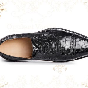 Handmade men’s black crocodile-style textured leather lace-up dress shoes with a polished finish. Crafted with genuine leather upper, cushioned insole, leather lining, and durable outsole for all-day comfort and support. Designed for weddings, parties, office wear, and formal business occasions. A premium handmade shoe that blends luxury, craftsmanship, and timeless sophistication for modern gentlemen. mens formal shoes
wedding shoes men
party wear shoes
business shoes men
polished dress shoes