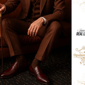 May include: A person in a brown suit and matching shoes sits on a brown leather couch, holding a cane. The shoes are a deep burgundy color. The image includes the text "Innovative REAL LEATHER" and "Opulent Vogue LEATHER."