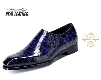 May include: A navy blue leather slip-on shoe with a textured, crocodile-like pattern. The shoe has a sleek design and a low heel. The words "Innovative Real Leather" are printed on the upper left. The Opulent Vogue Leather logo is on the right.
