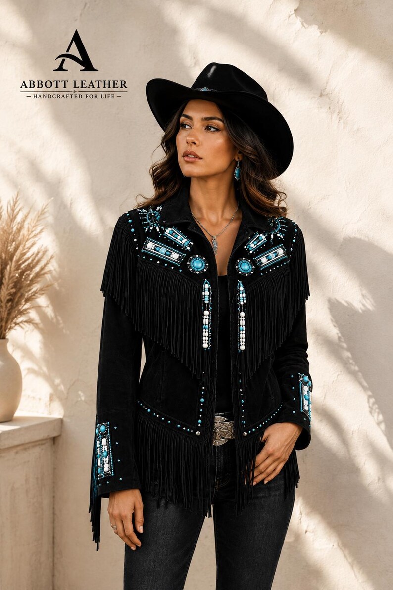 May include: A black jacket featuring long fringe detailing across the chest and sleeves. The garment is adorned with intricate beadwork in shades of turquoise, white, and silver, including circular turquoise accents and geometric patterns.