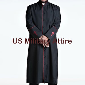 May include: Black clergy robe with red trim and cross embroidery on the sleeves. The robe has a mandarin collar and a button-down front. The text "US Military Attire" is printed on the bottom left of the image.
