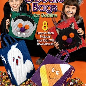 May include: A craft book titled Plastic Canvas Goodie Bags for Goblins featuring 8 easy-to-stitch projects. The cover displays four handmade tote bags with Halloween designs: a vampire, a black cat, a white ghost, and a piece of candy corn.
