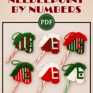 May include: Six plastic canvas needlepoint horse head ornaments with yarn manes and candy cane handles. The text reads PLASTIC CANVAS NEEDLEPOINT BY NUMBERS and PDF. The horses feature red, green, and white striped or solid patterns with yarn loops.