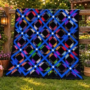 May include: A quilt featuring a lattice pattern of solid blue strips intersecting over a black background. The design incorporates squares of multi-colored, patterned fabric in shades of red, yellow, green, and purple, with small white squares at each intersection.