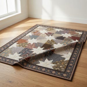 May include: A rectangular quilt with a star pattern. The quilt features a patchwork design with various earth-toned fabrics, including beige, brown, and burgundy. The border has a floral pattern. The quilt is folded over, revealing the underside.