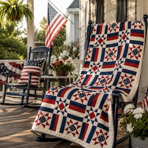 May include: A quilt featuring a patriotic pattern of red, white, and blue stars and stripes draped over a black wooden rocking chair. The quilt displays a repeating geometric design with star motifs and solid color blocks in a classic Americana style.