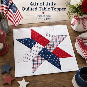 May include: A square 12.5 inch by 12.5 inch quilted table topper featuring a central star pattern in red, white, and blue fabrics with star, plaid, and solid prints on a white background, with text reading 4th of July Quilted Table Topper.