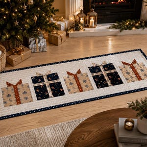 May include: A rectangular quilted table runner featuring a repeating pattern of five gift boxes. The gifts alternate between tan fabric with blue snowflakes and dark navy fabric with candy cane prints, all finished with a dark blue polka dot border.