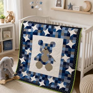 May include: A patchwork quilt featuring a central teddy bear motif in shades of blue, beige, and white. The quilt is bordered by a pattern of blue and white checkered squares and white stars, finished with a thin green edge trim.