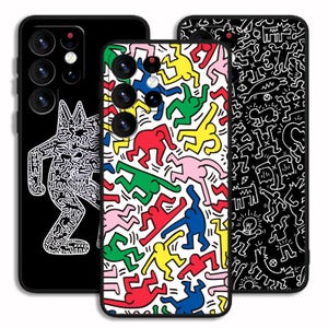 May include: Three phone cases with vibrant designs. One case is black with a white dog-like figure. The second case is white with colourful figures in red, green, yellow, pink, and blue. The third case is black with white abstract figures.