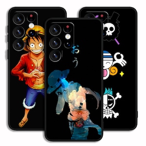 May include: Three black phone cases featuring anime-style illustrations. One case depicts a character in a red jacket and straw hat. Another has a blue and white artistic design with Japanese text. The third case displays skull and crossbones designs.