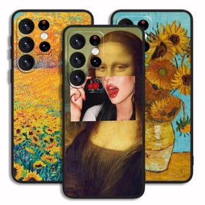 May include: Three phone cases with different artistic designs. The first case features a field of yellow sunflowers. The second case features a portrait of a woman with a cherry in her mouth. The third case features a vase of sunflowers against a blue background.