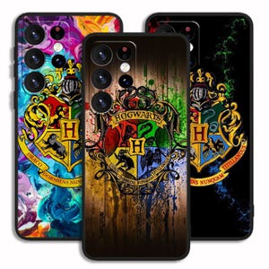May include: Three different phone cases with a Hogwarts house theme. The cases feature the Hogwarts crest with the house colors and mascots. The cases are made of a hard plastic material and have a glossy finish.