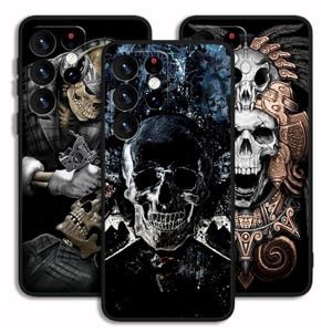 May include: Three black phone cases with skull designs. One case features a skull with a tattoo gun, another has a central skull graphic, and the third showcases a skull with ornate headdress details. The cases have a glossy finish.