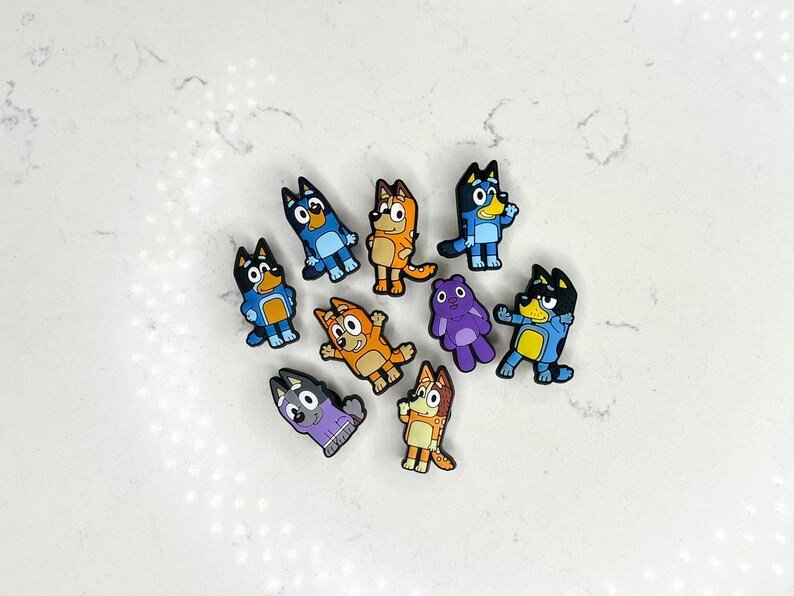 May include: A set of nine colourful cartoon dog and cat character charms. The charms are made of rubber and feature various poses and expressions. The charms are perfect for adding a playful touch to any project.