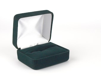 May include: An empty green velvet ring box with a white interior.