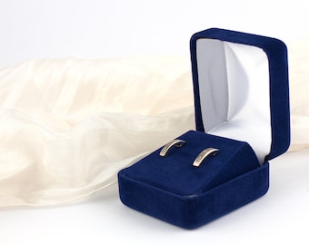 May include: A pair of silver earrings in a blue velvet jewellery box.