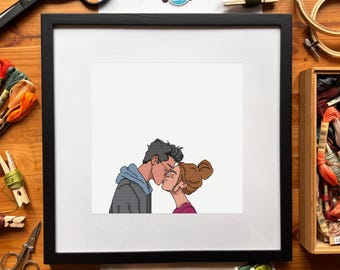 May include: Framed cross-stitch art featuring a couple kissing. The artwork depicts a man in a gray hoodie and glasses kissing a woman with a bun, wearing a pink shirt. The frame is black, and the art is set against a white background. The text "Nick & Kathy" is at the top.