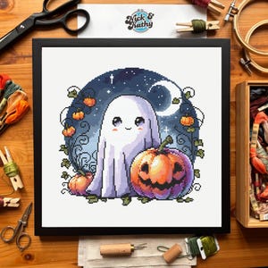 May include: Cross-stitch art in a black frame featuring a cute ghost and jack-o'-lantern. The background is a night sky with a crescent moon and stars. The artwork is surrounded by green vines and small pumpkins. The text "Nick & Kathy" is in the upper right corner.