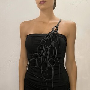 "Handmade necklace with unique black cable design – avant-garde jewelry with modern texture and style.
