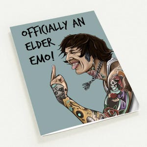 May include: A greeting card with the text "OFFICIALLY AN ELDER EMO!" features a cartoon illustration of a person with tattoos, sticking out their tongue and flipping the bird. The card has a light blue background.
