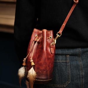 Carved patterned bucket bag with feather pendant Shoulder bag Crossbody bag is highly customisable handmade leather bag