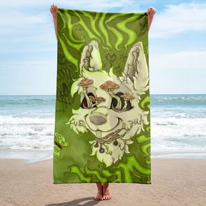 May include: A green beach towel featuring a cartoon-style white dog with mushroom eyes and a smiling expression. The towel has a green background with swirling patterns and a butterfly. The dog has a collar with charms.