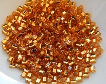 宝石 TOHO 11/o Triangle Beads 20 Grams Silver Lined Topaz Seed
