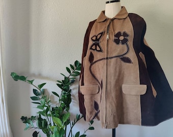 May include: A brown suede jacket with a zipper closure and a floral design. The jacket has a brown and black color scheme and features a butterfly and flower design.