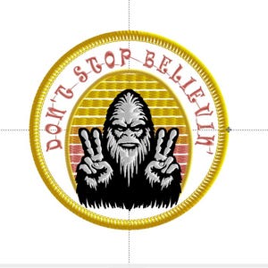 May include: A round, gold embroidered patch with a white background. The patch features a black silhouette of Bigfoot with a red and yellow sunset behind him. The text "Don't Stop Believin'" is written in pink around the edge of the patch.