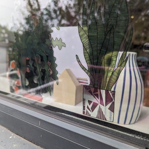 Pilea Pot Plant window Vinyl by Hannah Broadway
view from outside- looking in