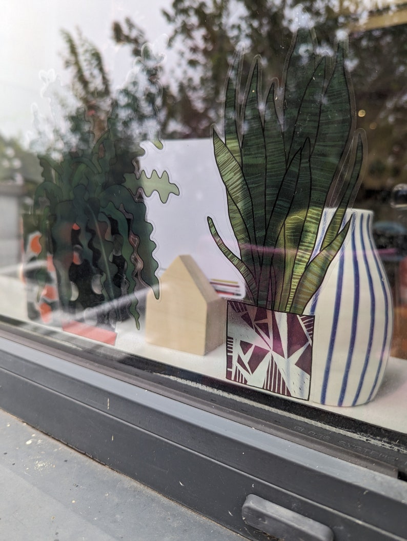 Pilea Pot Plant window Vinyl by Hannah Broadway
view from outside- looking in