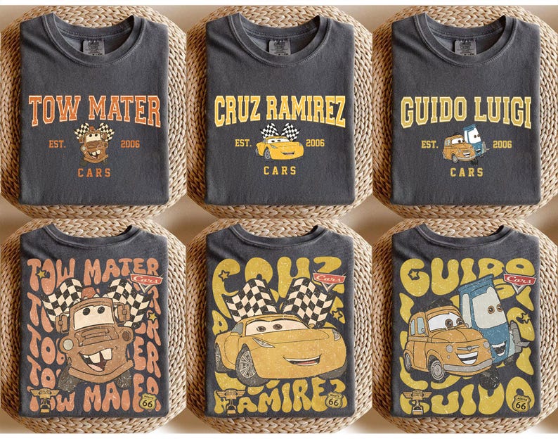 May include: Six charcoal gray t-shirts featuring designs from the Cars movie. Each shirt displays a character's name in a vintage font, along with the text "EST. 2006 CARS" and a cartoon image of the character. The designs include Tow Mater, Cruz Ramirez, and Guido Luigi.