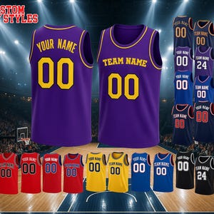 May include: A purple basketball jersey with yellow trim, featuring the text 'YOUR NAME' and 'TEAM NAME' with the number '00' in yellow. The image displays various color options of the jersey, including red, yellow, blue, and black, with the text 'CUSTOM ANY STYLES'.
