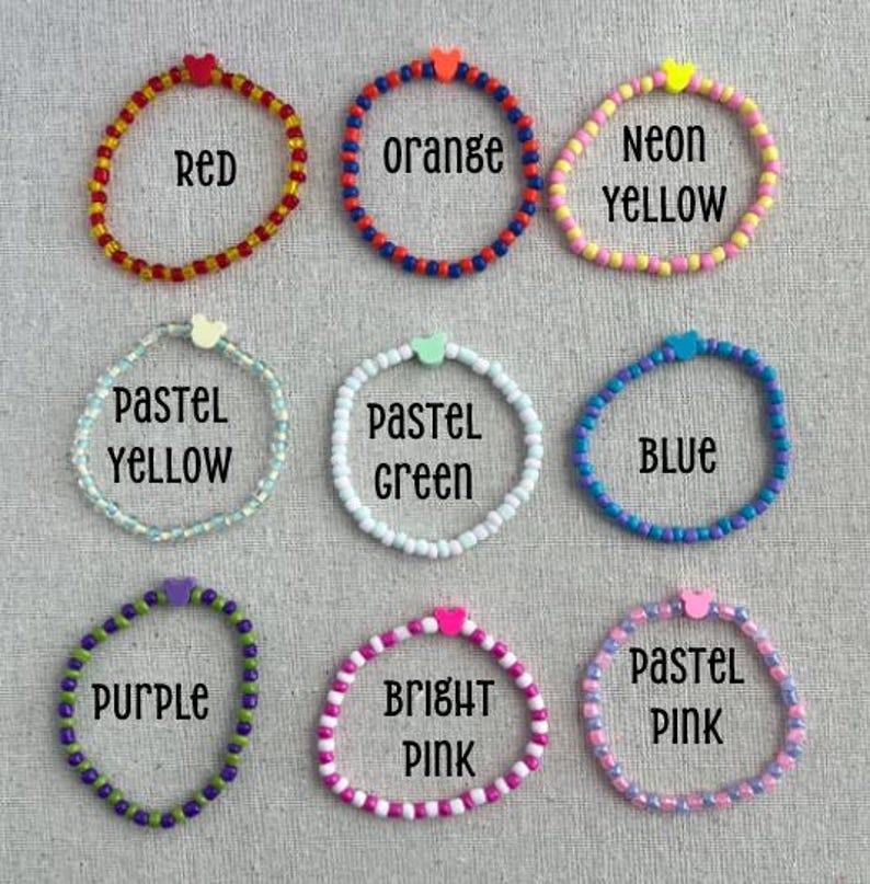 May include: Nine beaded bracelets in various colors, including red, orange, neon yellow, pastel yellow, pastel green, blue, purple, bright pink, and pastel pink. Each bracelet has a heart-shaped accent and a color-coordinated text label.