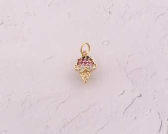 May include: A gold-colored ice cream cone charm with a loop for hanging. The ice cream is adorned with red, white, and black gemstones. The cone has a textured design.