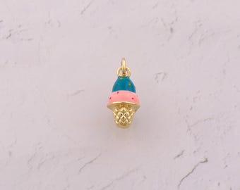 May include: A gold-colored ice cream cone charm with a blue top, pink middle, and a waffle cone base. The charm is small and detailed, perfect for jewelry making or adding to a charm bracelet.