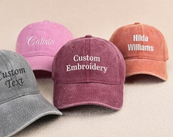 May include: Four baseball caps in various colors: gray, pink, burgundy, and orange. Each cap features custom text embroidery in white or black. The burgundy cap displays "Custom Embroidery," while the others have individual names or "Custom Text."