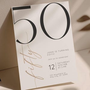 May include: A rectangular invitation card featuring the large black number 50 at the top. The word fifty is written in a tan script font vertically. Text includes John is turning fifty, join us to celebrate, Saturday 12th Feb at 3 PM, and 123 Anywhere St.