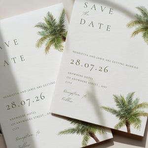 May include: Two white Save the Date cards featuring green palm tree illustrations. The text reads Save the Date, Henrietta and Jamie are getting married, 28.07.26, Anywhere Hotel, 123 Anywhere Street, Any City, and Reception to Follow. A logo with JA is visible.