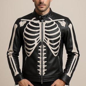 May include: Black leather jacket featuring a cream-colored skeleton design on the front and sleeves. The jacket has a zipper closure, side pockets, and a stand-up collar. A unique and edgy outerwear piece.