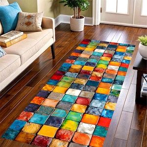 May include: A rectangular area rug with a vibrant, colorful design. The rug features a pattern of rectangular blocks in various colors, including red, blue, yellow, and green. The rug is placed on a hardwood floor.