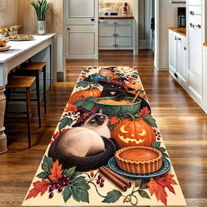 May include: A rectangular runner rug featuring a Halloween theme with a Siamese cat, a black cat wearing a witch hat, pumpkins, a pie, and cinnamon sticks. The design includes autumn leaves and berries on a cream background, creating a festive scene.