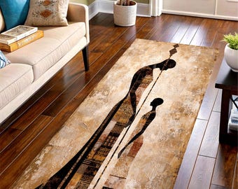 May include: Rectangular area rug with an abstract design featuring two silhouetted figures in black and brown against a beige background. The rug has a distressed, textured appearance, suitable for a living room or entryway.