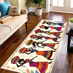 May include: A rectangular cream-colored rug featuring a repeating pattern of silhouetted figures carrying vessels on their heads. The figures are dressed in colorful, patterned dresses in shades of red, orange, yellow, and purple. The rug has a decorative border.