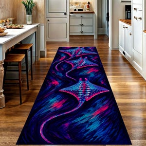 May include: A long rectangular runner rug featuring a vibrant artistic print of three stingrays swimming in a deep blue and black ocean current. The stingrays are decorated with bright pink, purple, and light blue patterns across their bodies.